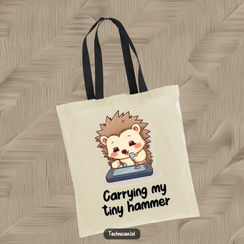 Funny hedgehog tote bag showing a cute hedgehog with a miniature hammer attempting to repair a smartphone screen with determination.